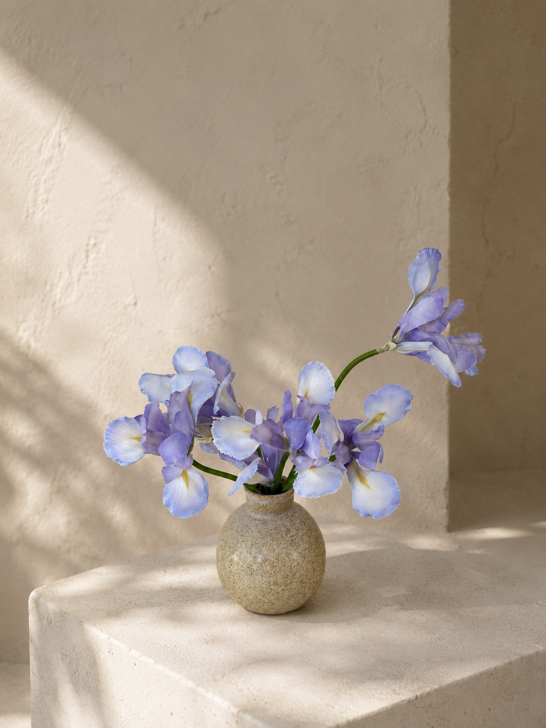 PO009 delicate sculptural iris arrangement in a ceramic vessel